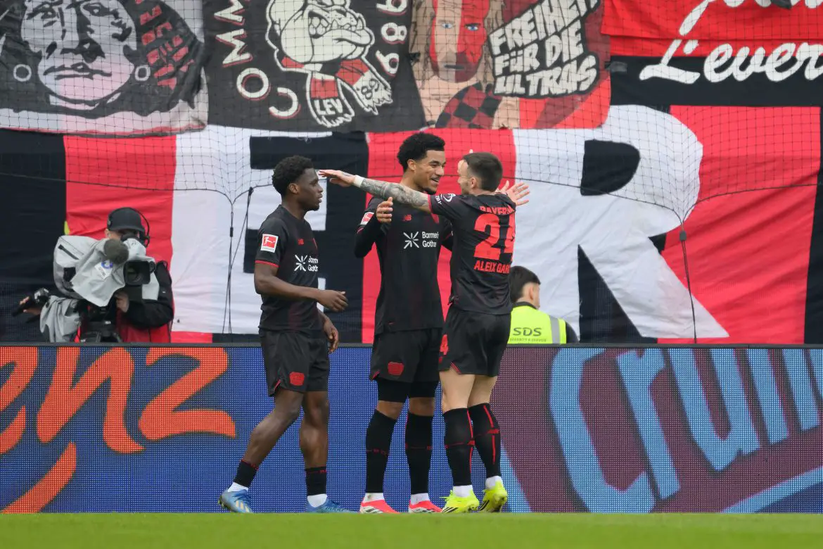 Bayer Leverkusen players celebrate during a Bundesliga match.