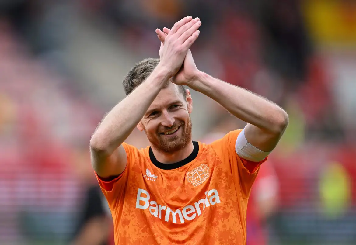 Lukas Hradecky applauds the travelling Bayer Leverkusen fans following their Bundesliga win against Heidenheim.