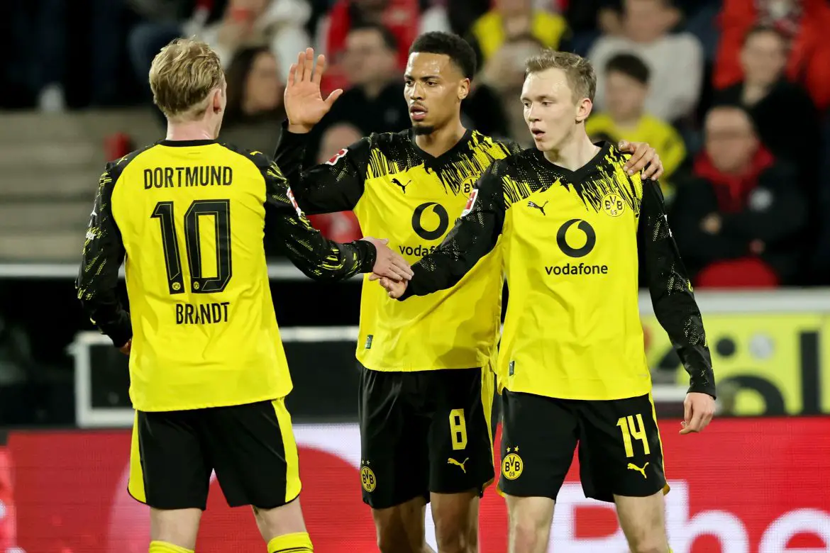 Borussia Dortmund players celebrate after scoring the second goal versus 1. FC Köln in a Bundesliga match.