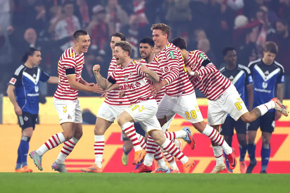 Köln forward Florian Kainz (center) celebrates scoring a crucial Bundesliga goal.