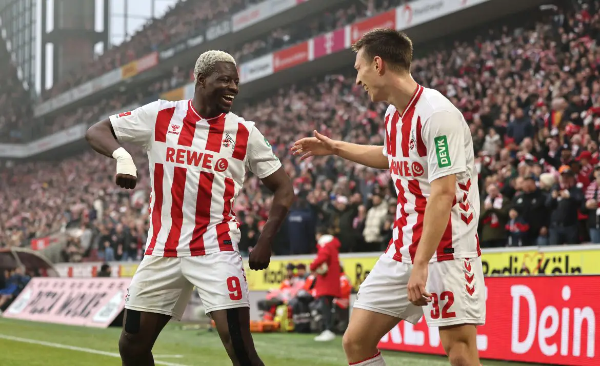 Köln striker Ragnar Ache (left) celebrates with teammate Kristoffer Lund (right) after scoring a dream goal in the Bundesliga on Saturday afternoon.
