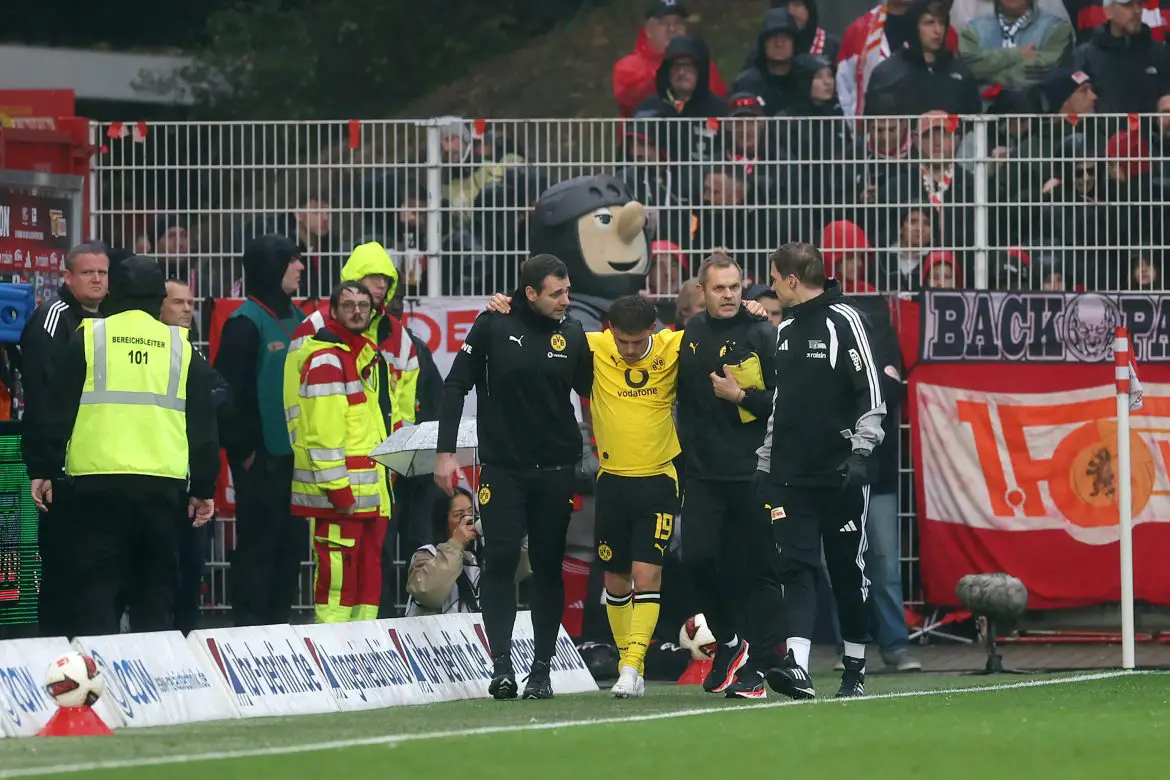 Borussia Dortmund attacker Konstantinos Karetsas being helped off the pitch.