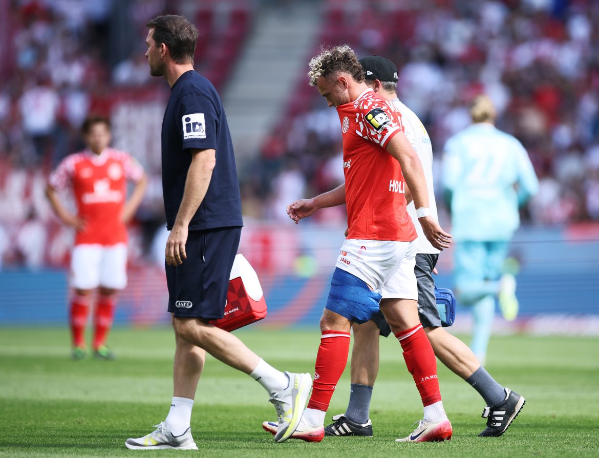 Mainz's Benedict Hollerbach exits the pitch injured on Sunday.