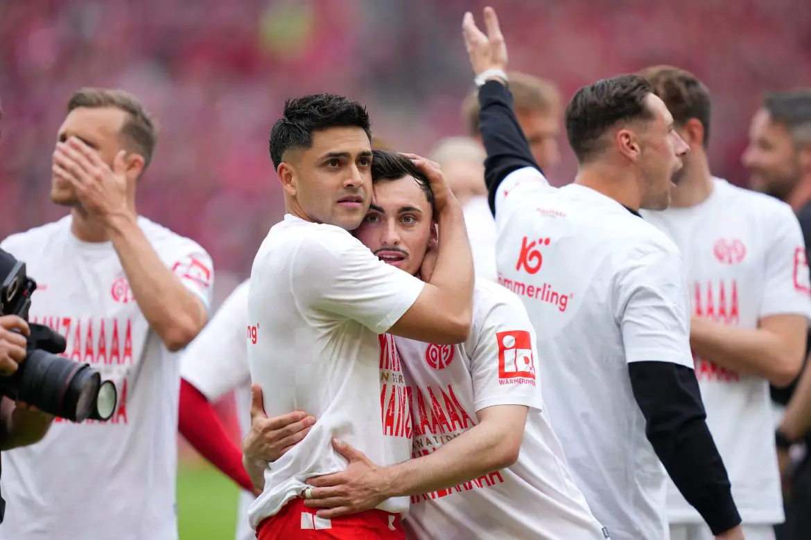Mainz's Nadiem Amiri (left) embraces teammate Paul Nebel after securing European football at the end of last season.