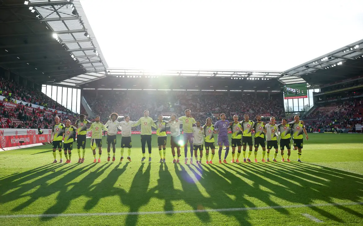 Borussia Dortmund celebrate in front of their travelling supporters after beating Mainz in the Bundesliga.