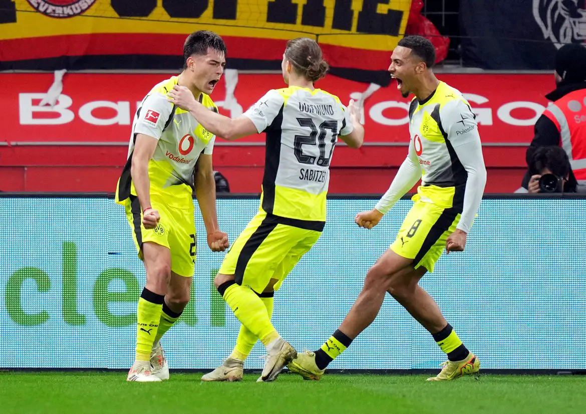 Chelsea defender Aarón Anselmino (far left) celebrates scoring a goal with his Borussia Dortmund teammates.