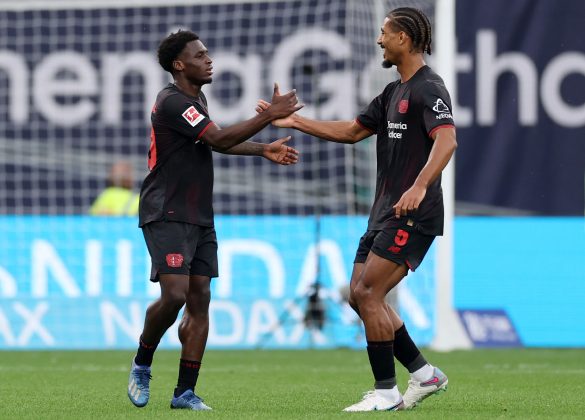 Bayer Leverkusen's Ernest Poku (left) celebrates scoring a Bundesliga goal.