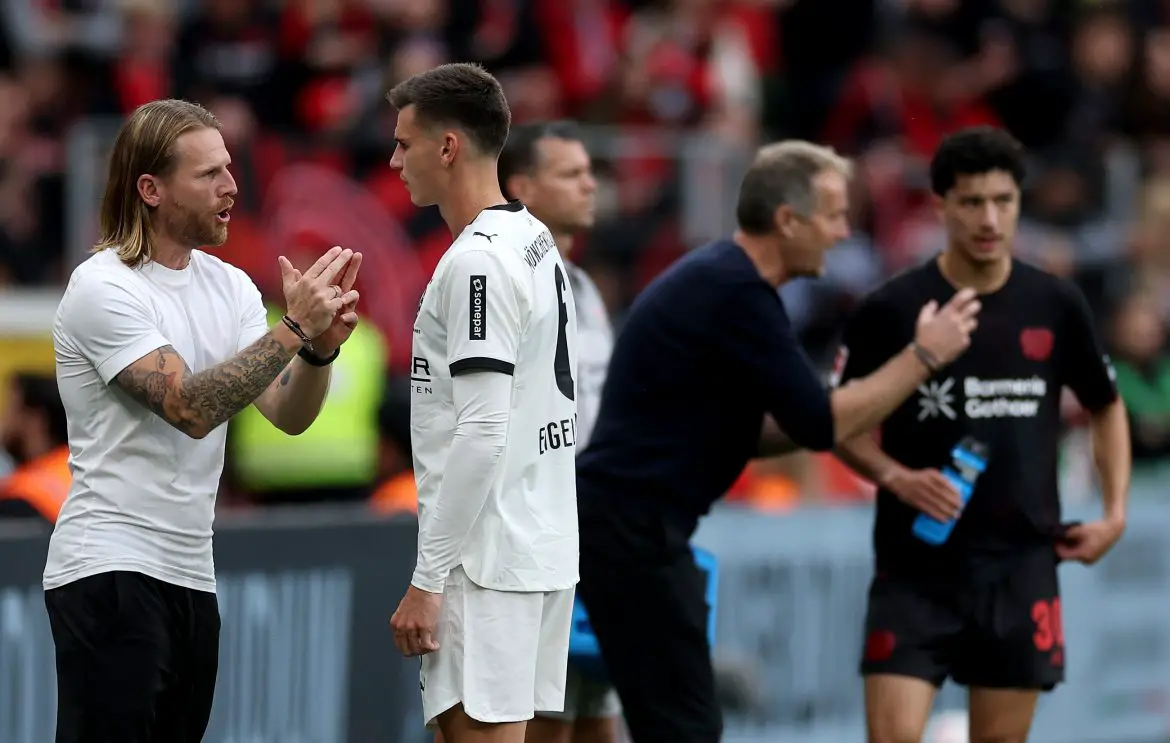 Borussia Mönchengladbach Interim trainer Eugen Polanski (left) speaks with Yannik Engelhardt (right) on the Bundesliga sidelines last weekend.