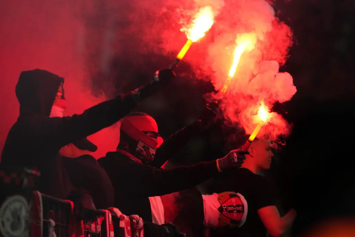 Bayer Leverkusen fans show support for their club by lighting flares.