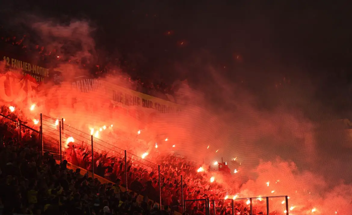 Union Berlin fans with flares in a Bundesliga match.