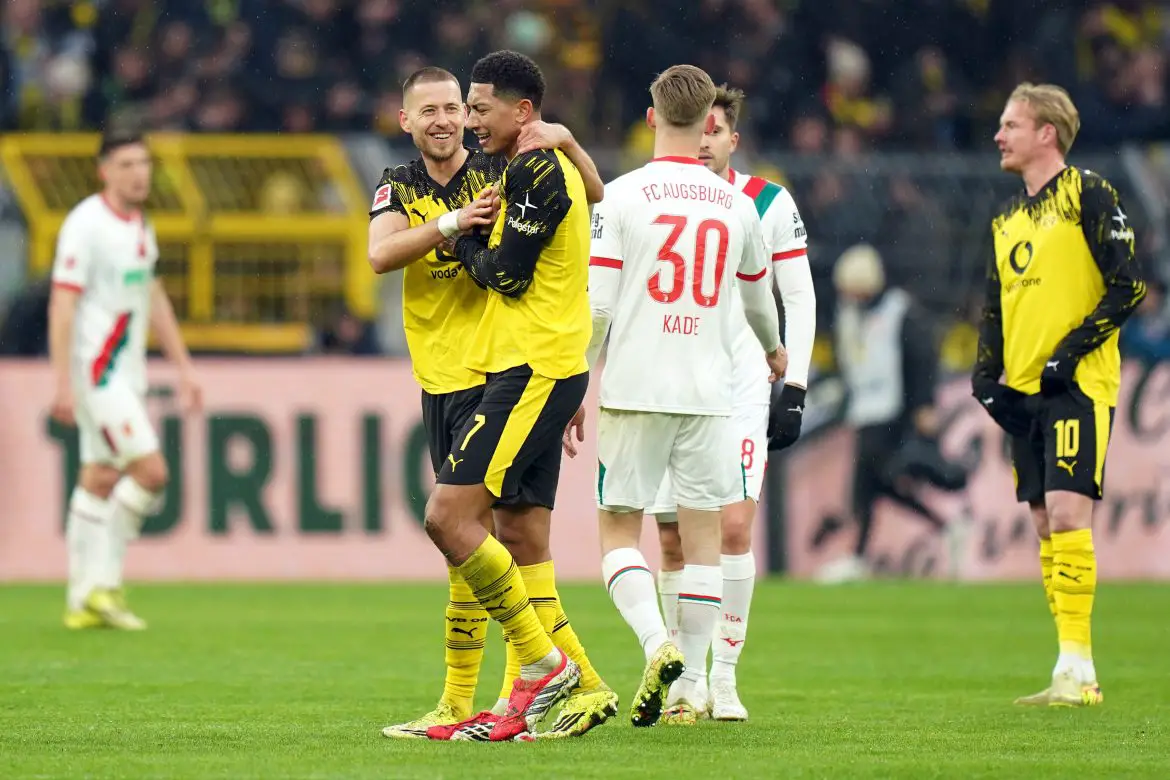 Borussia Dortmund players celebrate after netting against Augsburg in the Bundesliga.