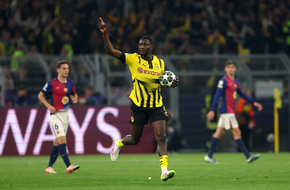Serhou Guirassy of Borussia Dortmund celebrates scoring against Barcelona.