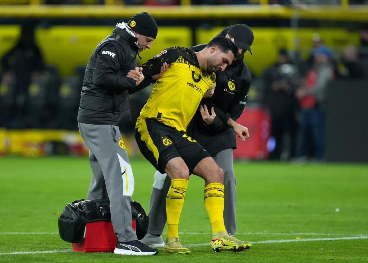 Borussia Dortmund captain Emré Can being helped off the pitch during Saturday's Bundesliga loss against Bayern Munich.