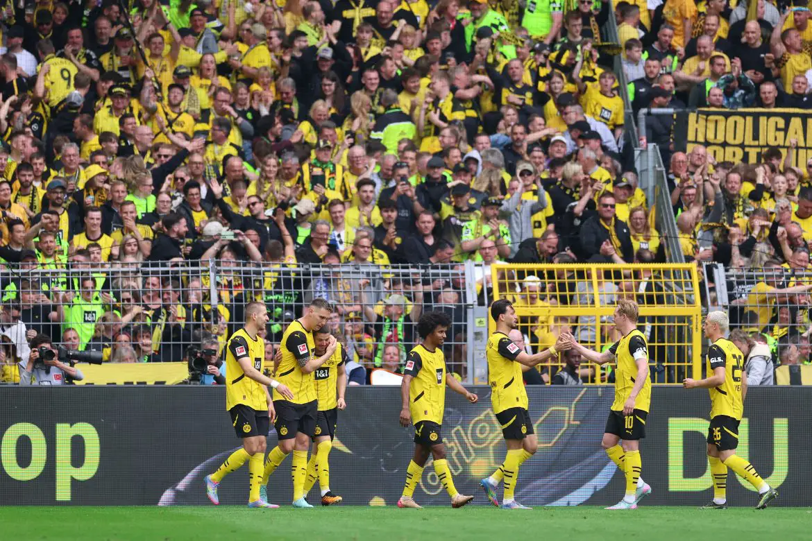 Borussia Dortmund celebrate scoring against Holstein Kiel to secure Champions League football.
