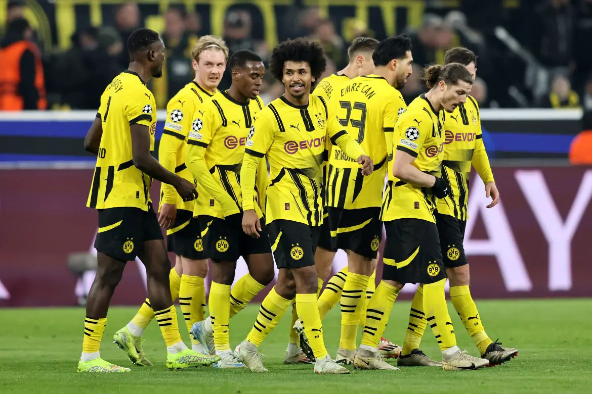 Karim Adeyemi celebrates opening the scoring with his Borussia Dortmund teammates against Lille in the Champions League.