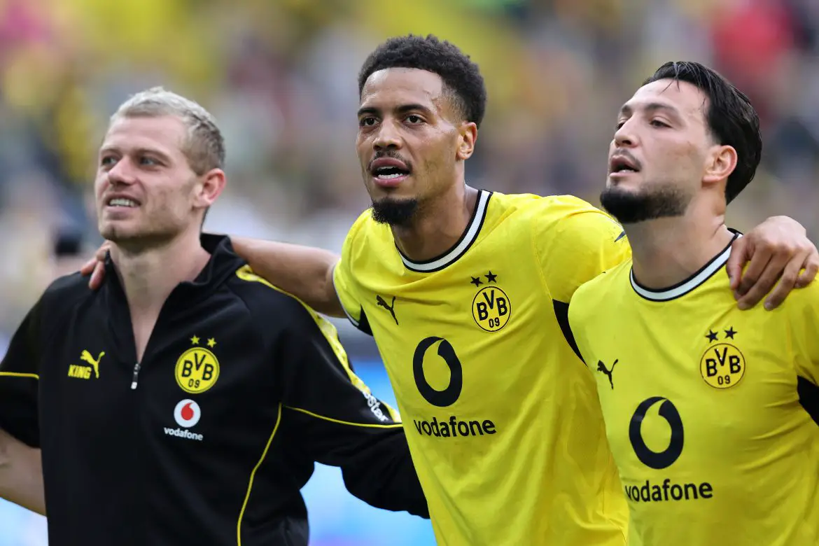Borussia Dortmund's Felix Nmecha (center) celebrates a Bundesliga victory with his teammates.