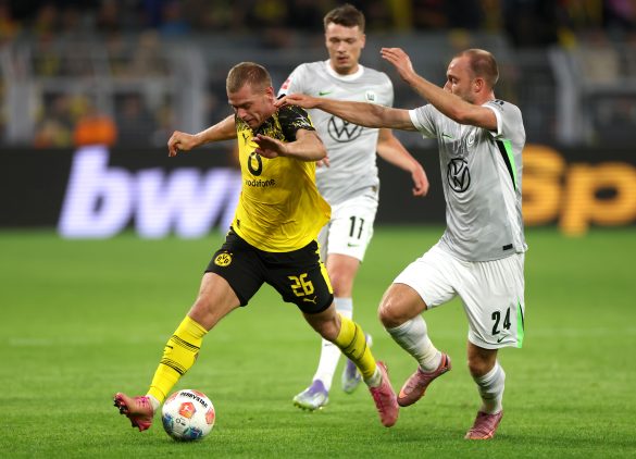 Julian Ryerson of Borussia Dortmund and Wolfsburg's Max Arnold compete for the ball.
