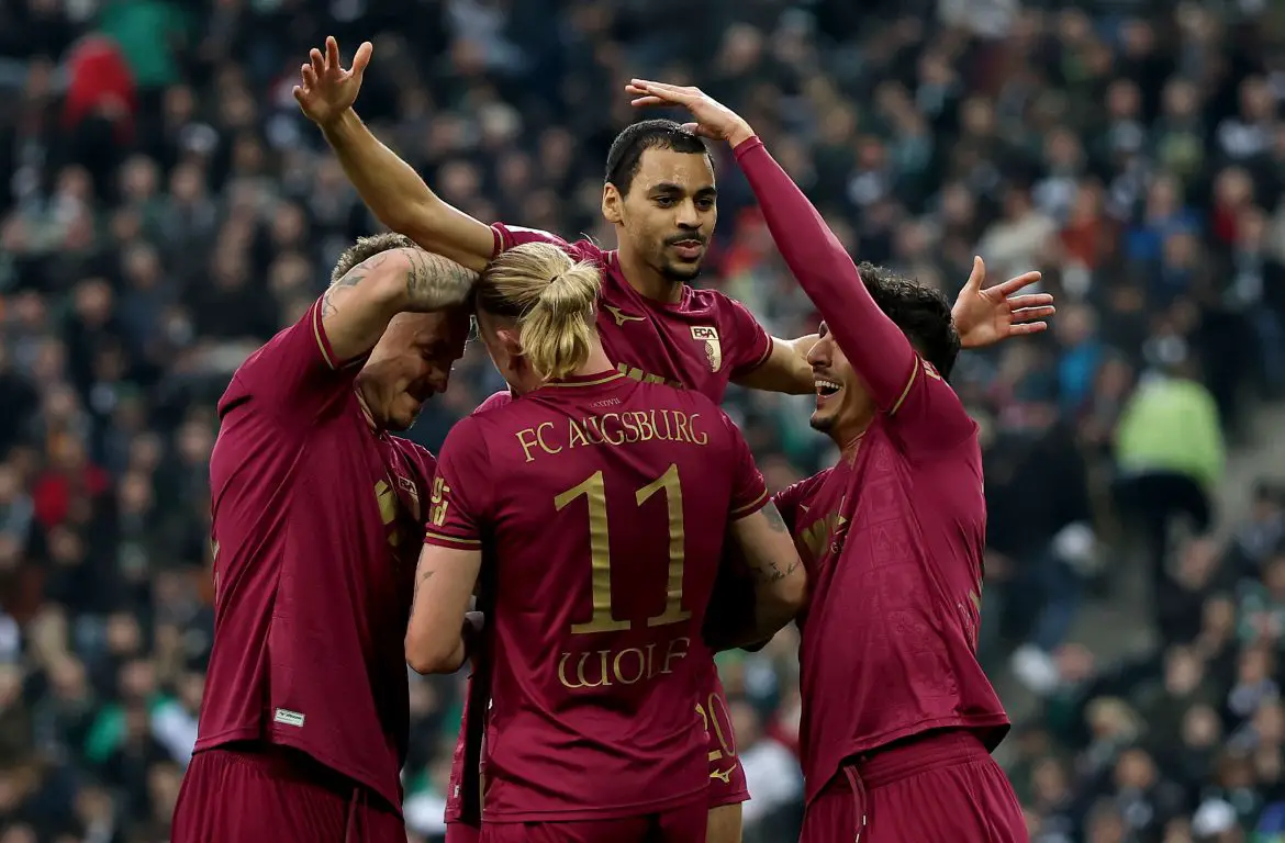 Augsburg attacking-midfielder Alexis Claude-Maurice celebrates scoring in the Bundesliga.
