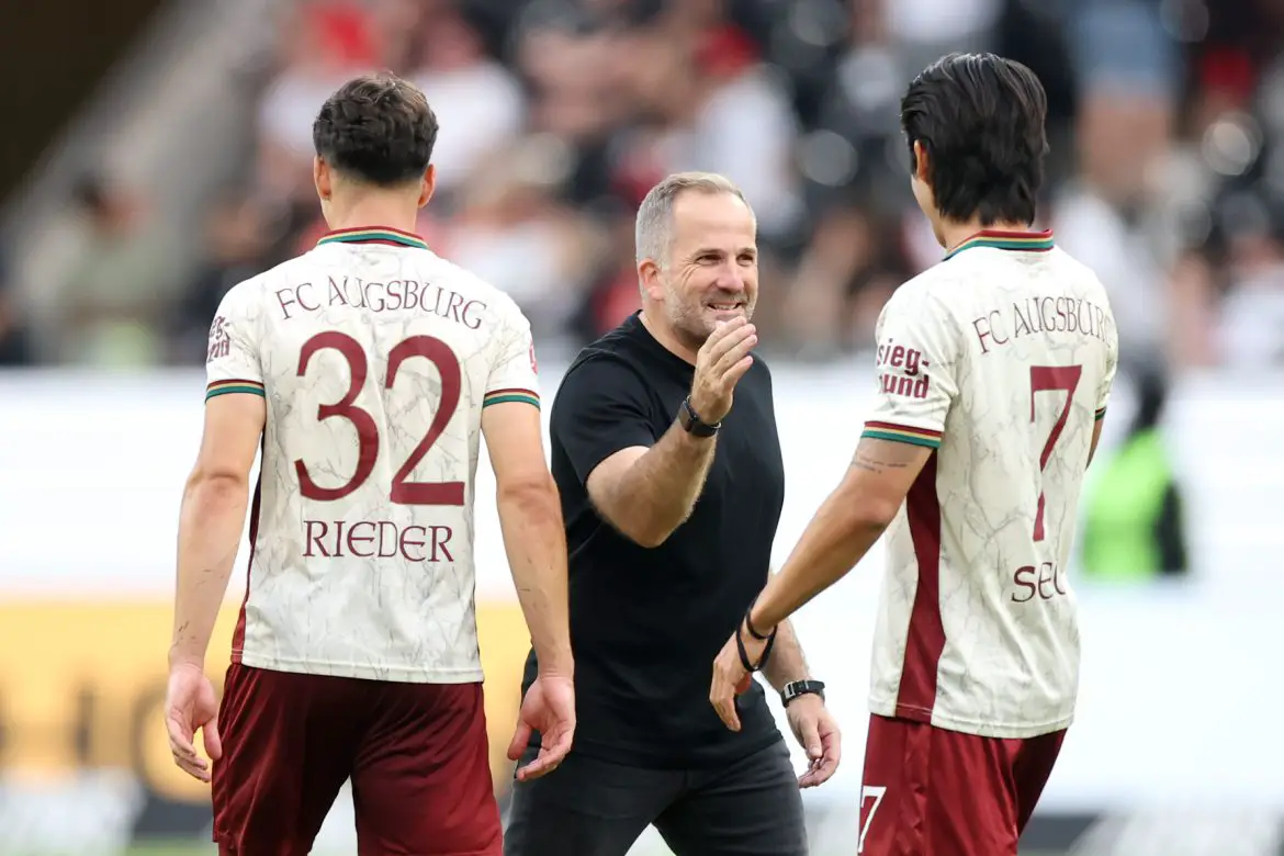 Augsburg's Manuel Baum (center) congratulates his players after Sunday's Bundesliga victory over Eintracht Frankfurt.