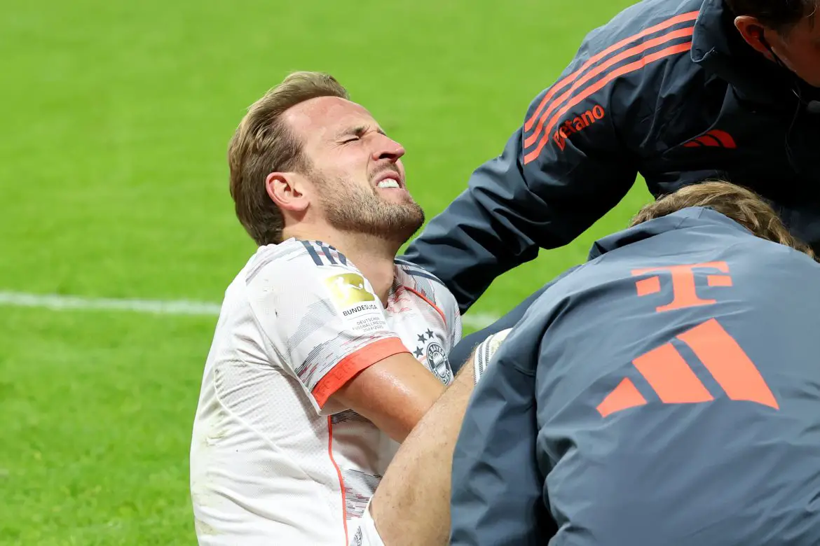 England's Harry Kane grimaces in pain during Saturday night's Bundesliga match.