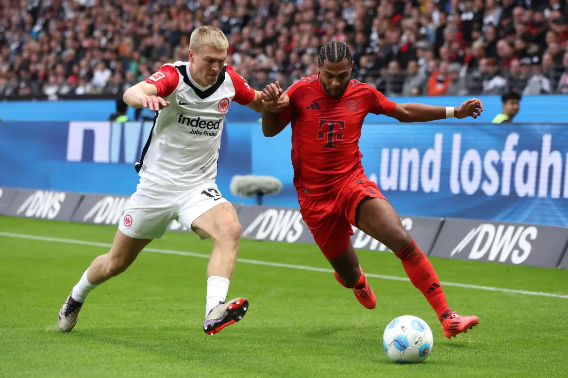 Eintracht Frankfurt defender Rasmus Kristensen battling with Bayern Munich forward Serge Gnabry for the ball.