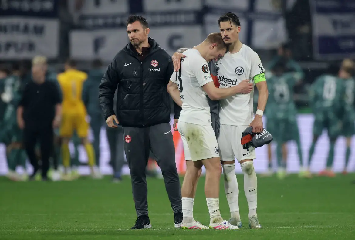 Eintracht Frankfurt captain Robin Koch consoles teammate Rasmus Kristensen at Deutsche Bank Park on Thursday evening.