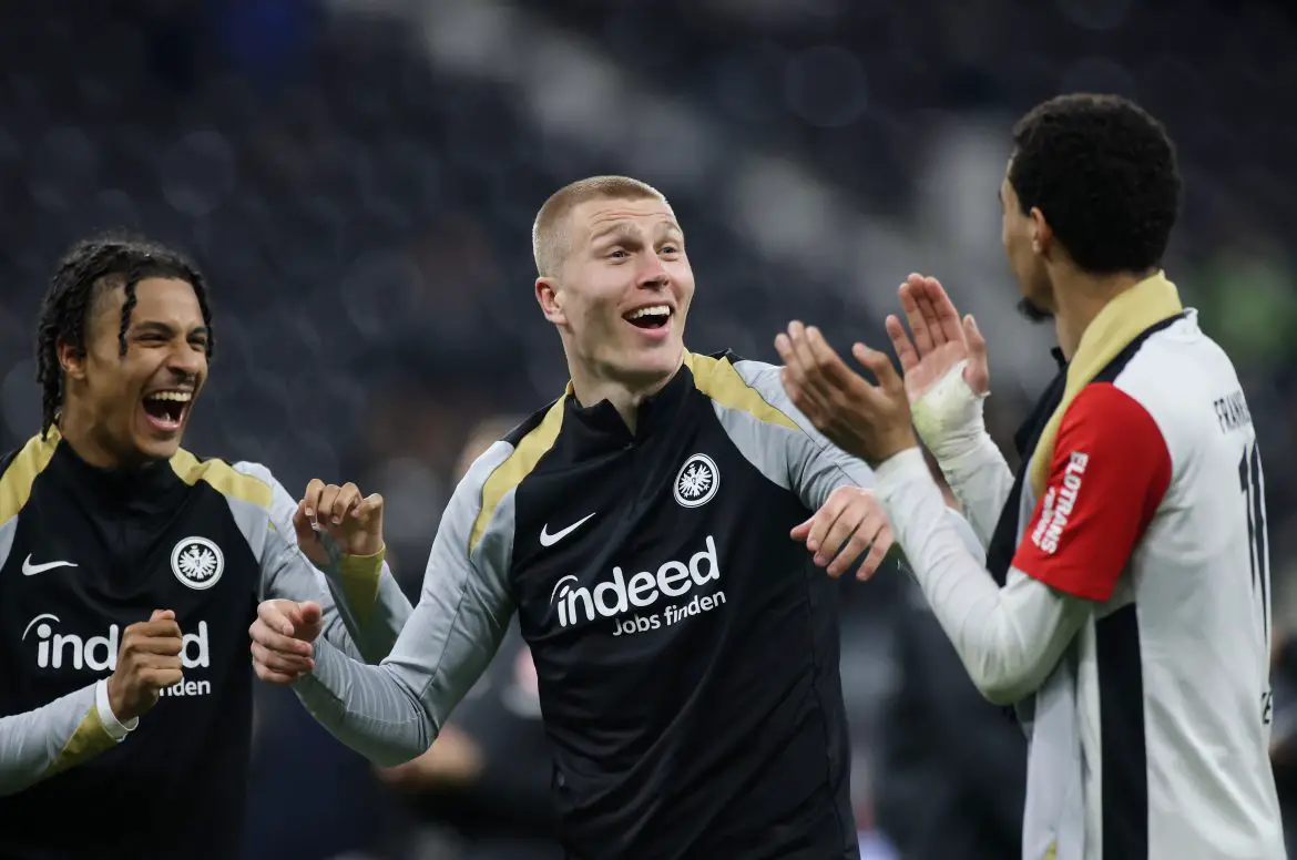 Rasmus Kristensen (centre) flanked by Eintracht teammates Hugo Ekitiké and Jean-Matteo Bahoya.