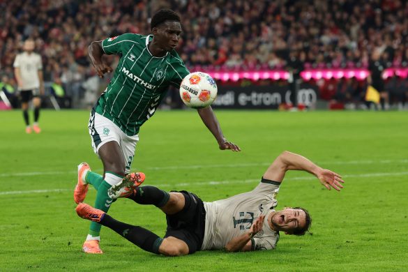 Werder Bremen central defender Karim Coulibaly (left) in a tangle with Bayern Munich's Leon Goretzka (right) in the Bundesliga.