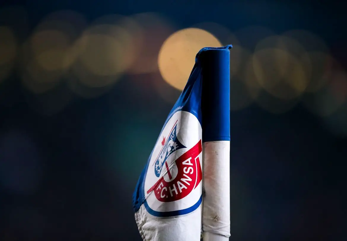A corner flag displays the FC Hansa Rostock logo.