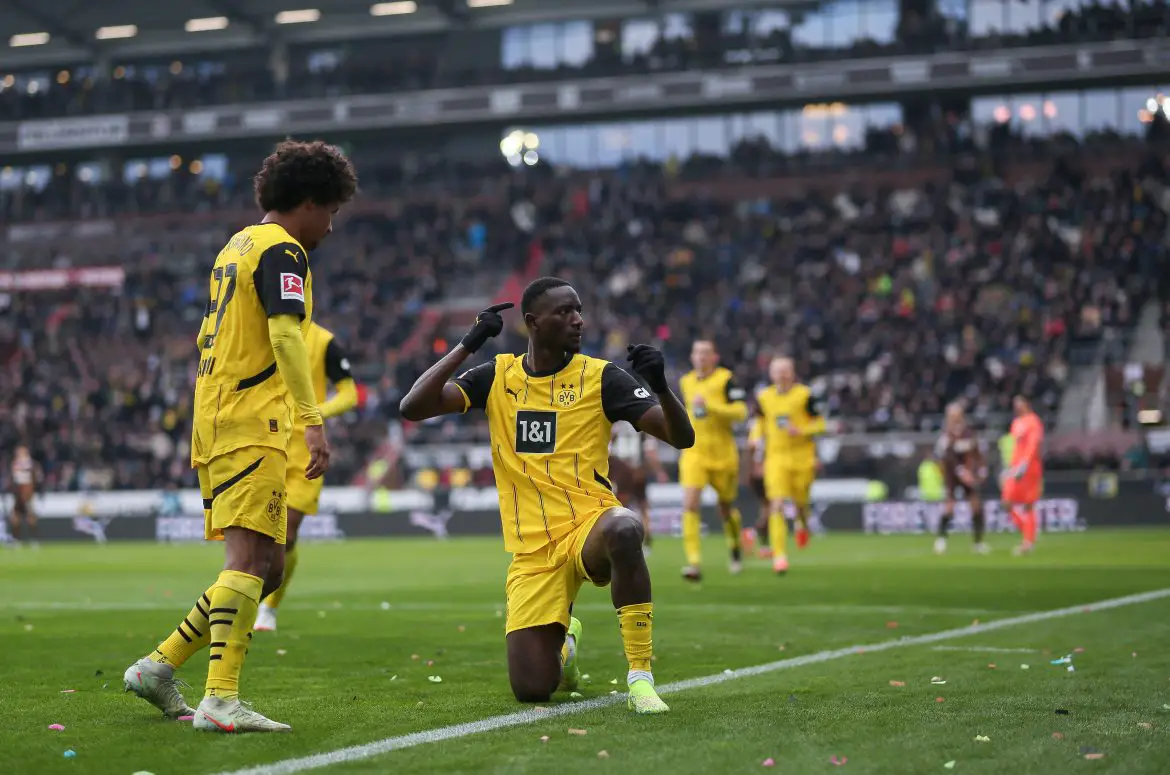 Karim Adeyemi celebrates with Serhou Guirassy for Borussia Dortmund.