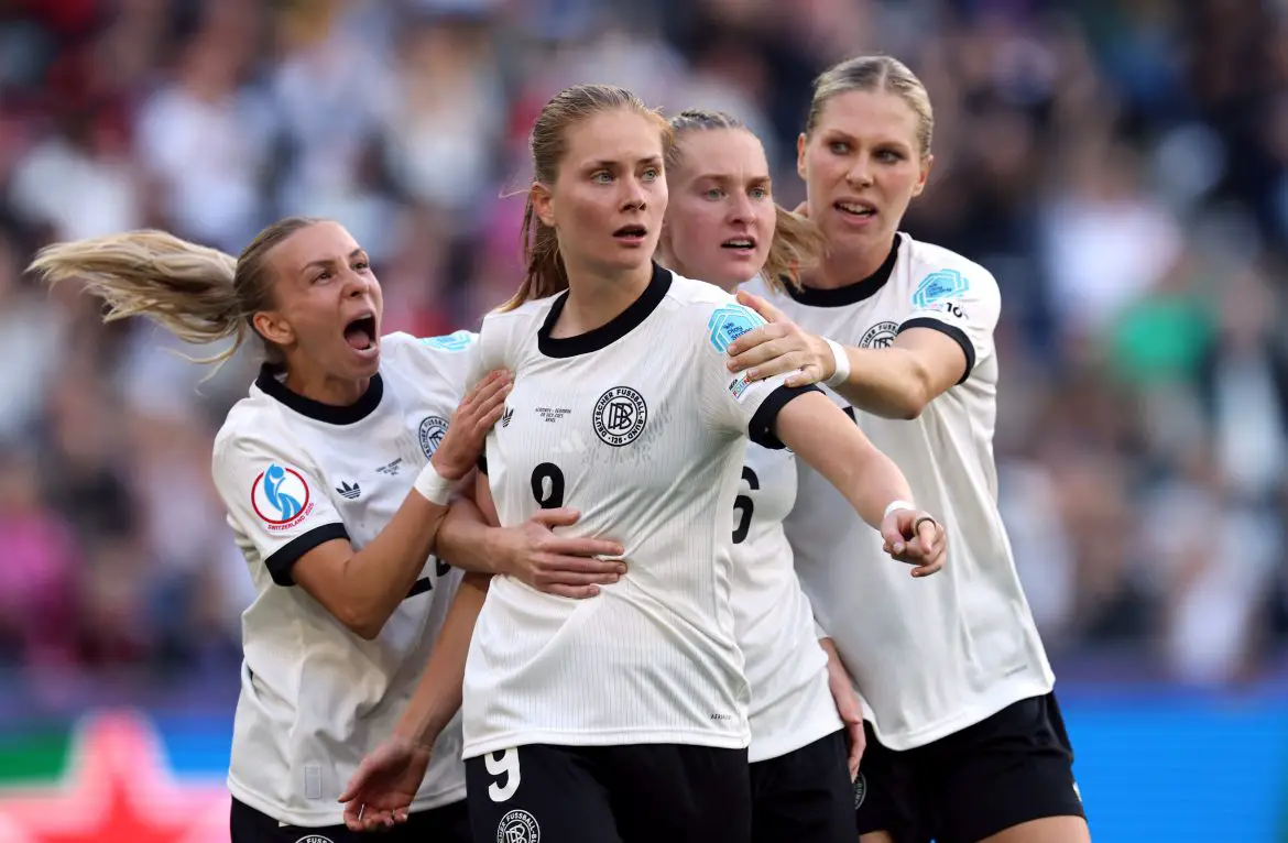 Germany's Sjoeke Nüsken is mobbed by her German women's national team colleagues after sinking a crucial penalty in Tuesday's European Championship group stage fixture.