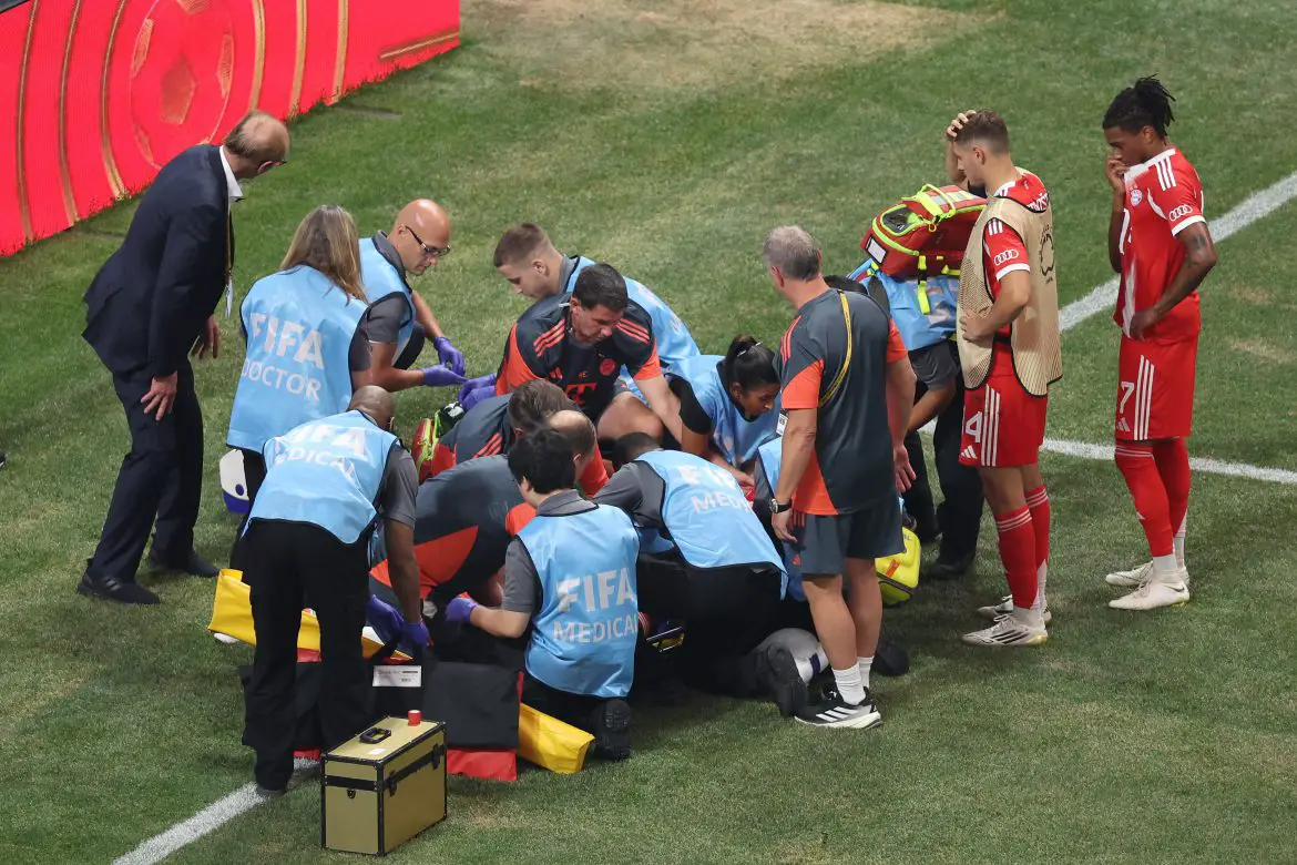 Players gather around Bayern Munich's Jamal Musiala following a horrific injury against PSG.