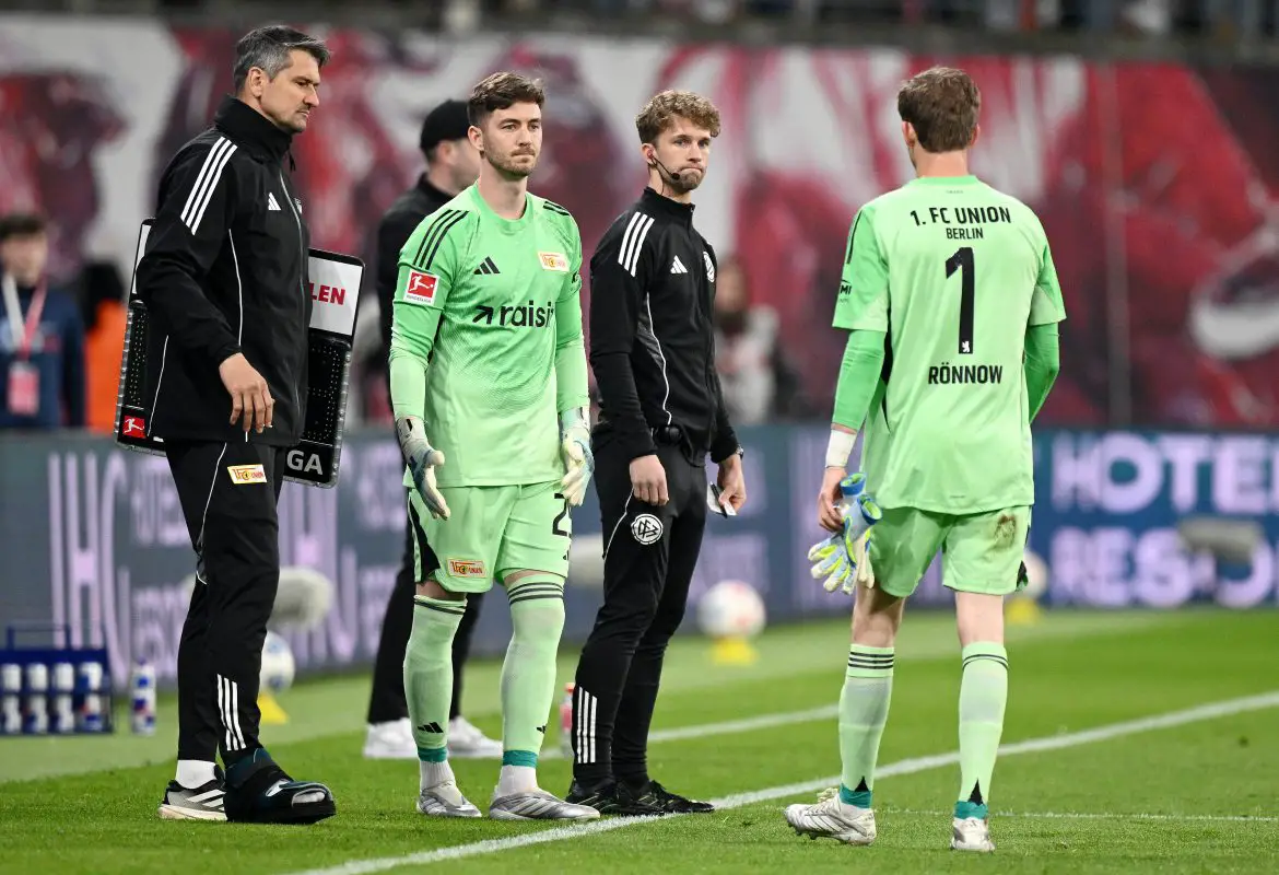 Union Berlin debutant keeper Carl Klaus (left) prepares to replace teammate Frederik Rønnow (right) during last night's Bundesliga match.