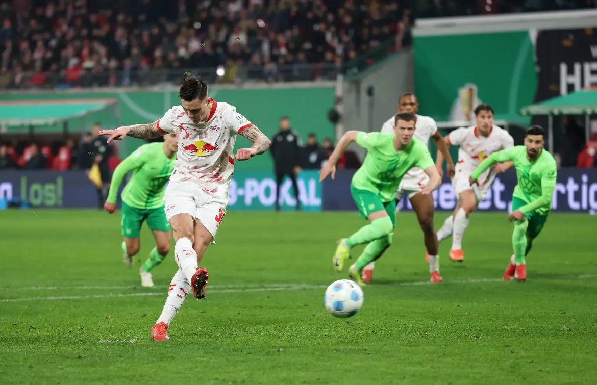 Benjamin Sesko of RB Leipzig scores after a controversial penalty decision against Wolfsburg in the DFB Pokal.