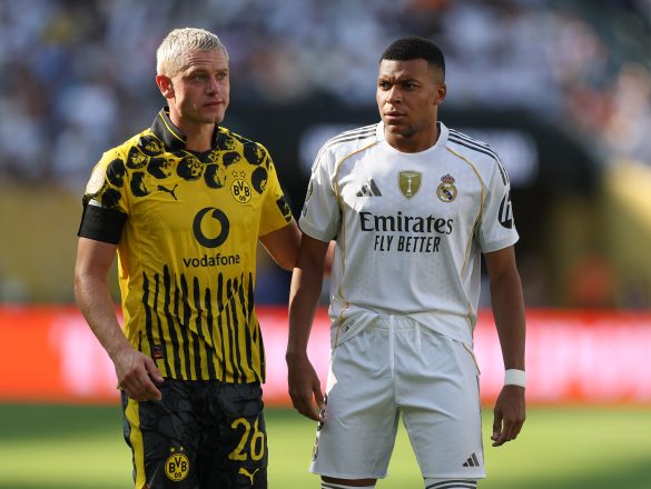 Julian Ryerson of Borussia Dortmund lining up alongside Real Madrid's Kylian Mbappe.