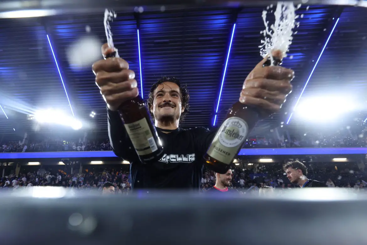 Paderborn midfielder Mika Baur celebrates promotion to the Bundesliga.