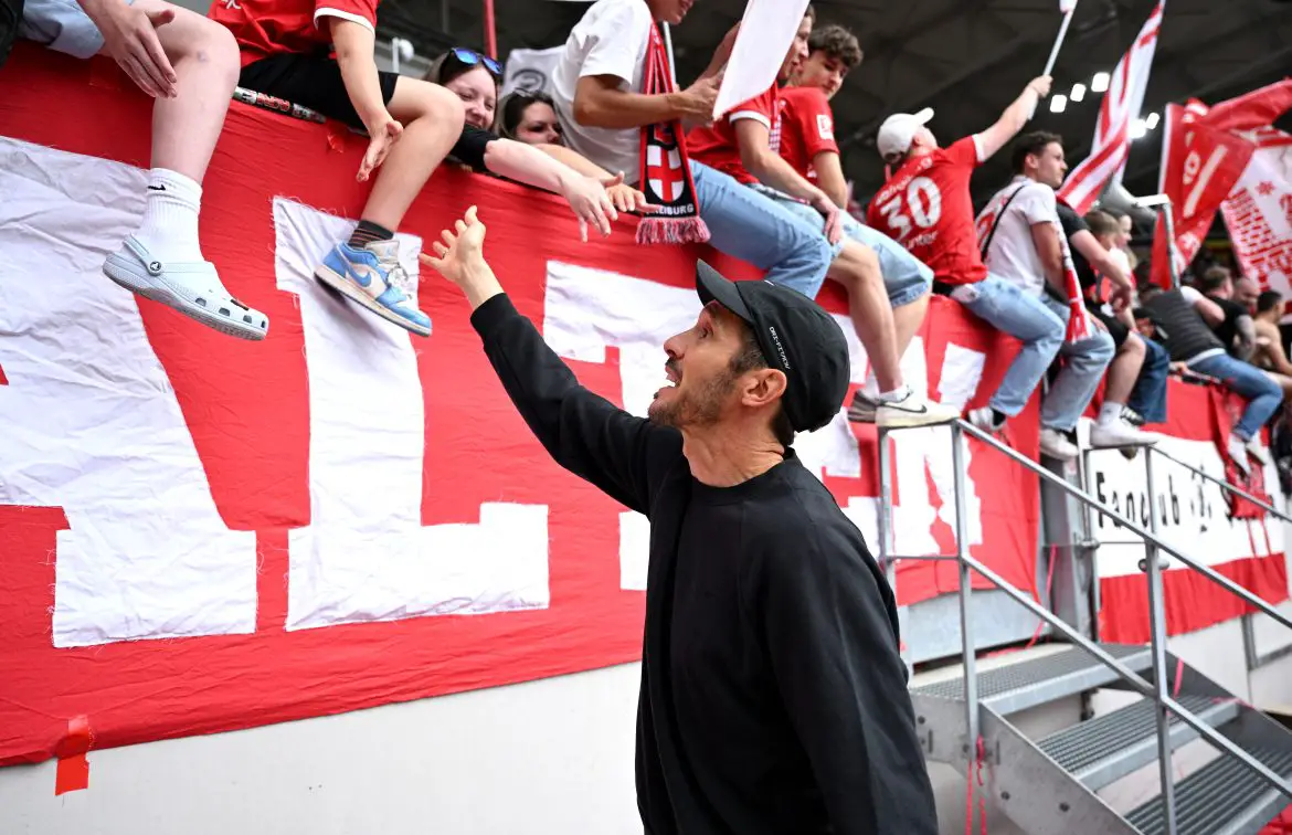 SC Freiburg head coach Julian Schuster interacts with fans at the Europa Park Stadion yesterday.
