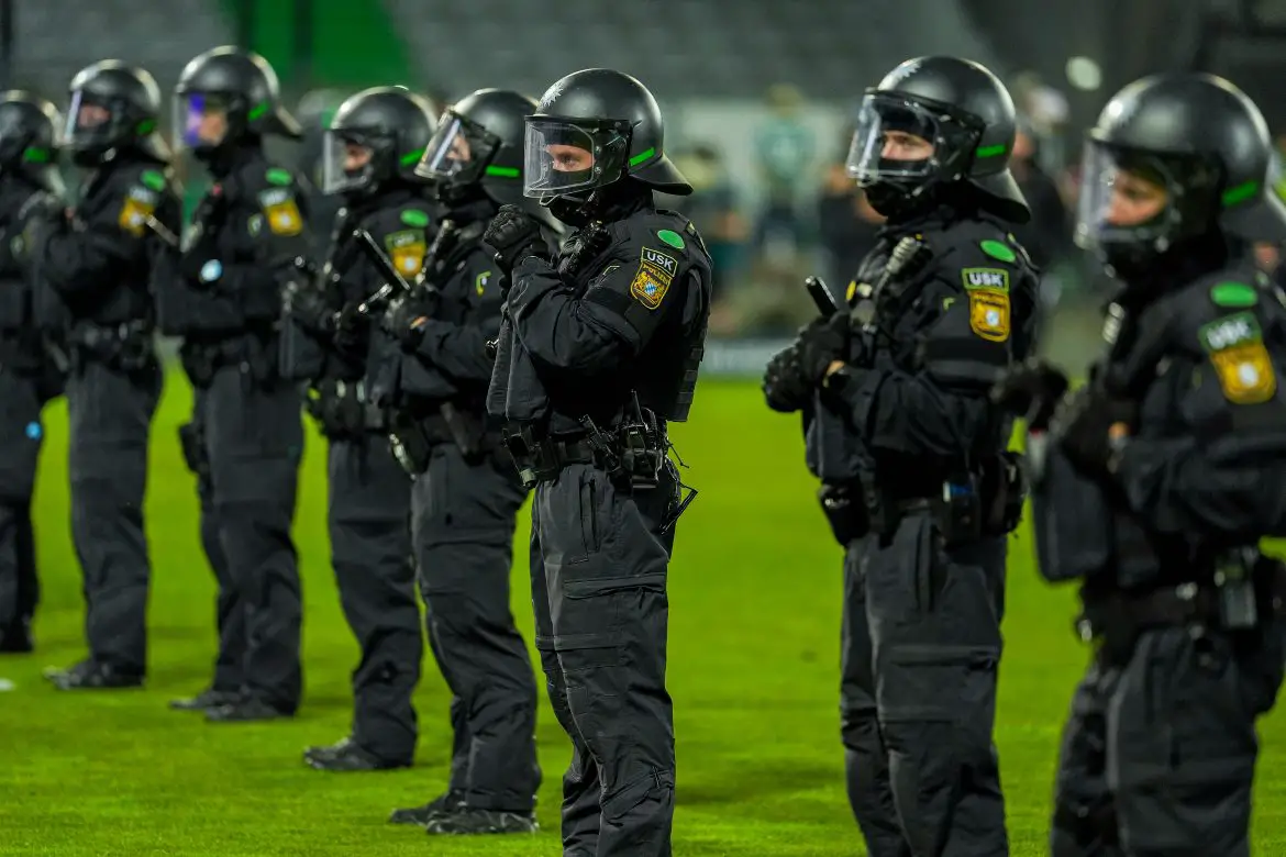Police officers line up on the Fürth pitch following the 2025/26 2. Bundesliga/3. Liga playoff second leg between SpVgg Greuther Fürth and Rot-Weiss Essen at Sportpark Ronhof.