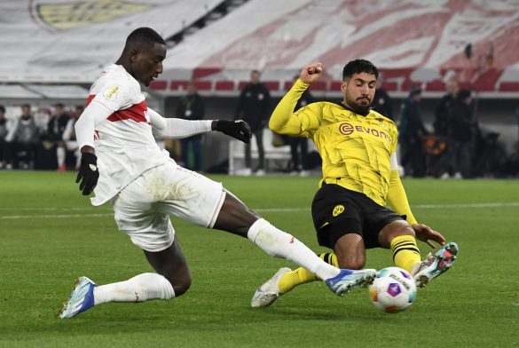 TOPSHOT - Stuttgart's Guinean forward #09 Serhou Guirassy (L) and Dortmund's German midfielder #23 Emre Can vie for the ball during the German Cup (DFB Pokal) round of 16 football match between VfB Stuttgart and Borussia Dortmund in Stuttgart, southwestern Germany on December 6, 2023. (Photo by Thomas KIENZLE / AFP) / DFB REGULATIONS PROHIBIT ANY USE OF PHOTOGRAPHS AS IMAGE SEQUENCES AND QUASI-VIDEO. (Photo by THOMAS KIENZLE/AFP via Getty Images)