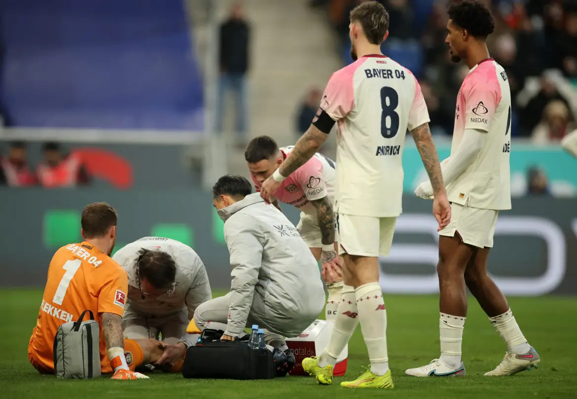 Bayer Leverkusen keeper Mark Flekken receives treatment during Saturday's Bundesliga defeat against Hoffenheim.