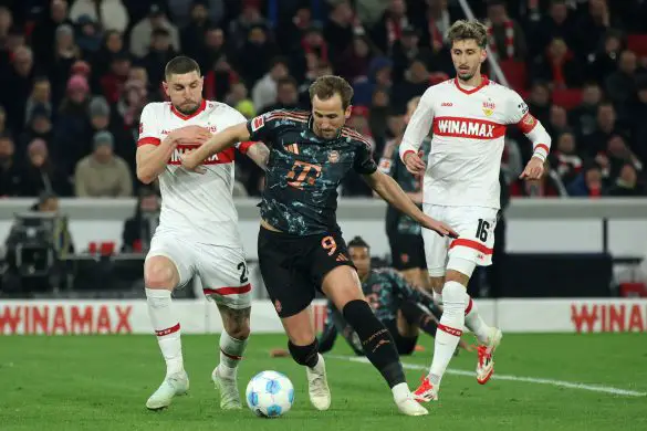 Harry Kane of Bayern Munich battles for the ball against Stuttgart's Deniz Undav and Atakan Karazor.