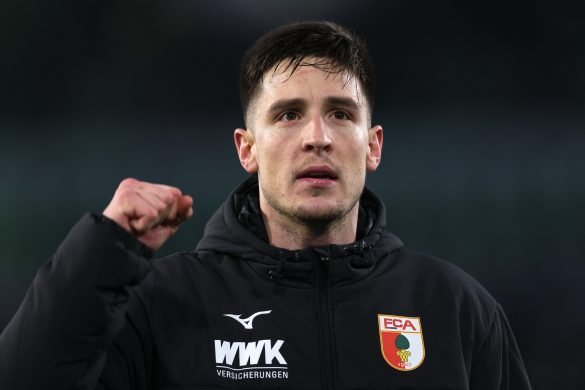 Augsburg interim captain Keven Schlotterbeck celebrates a Bundesliga victory.