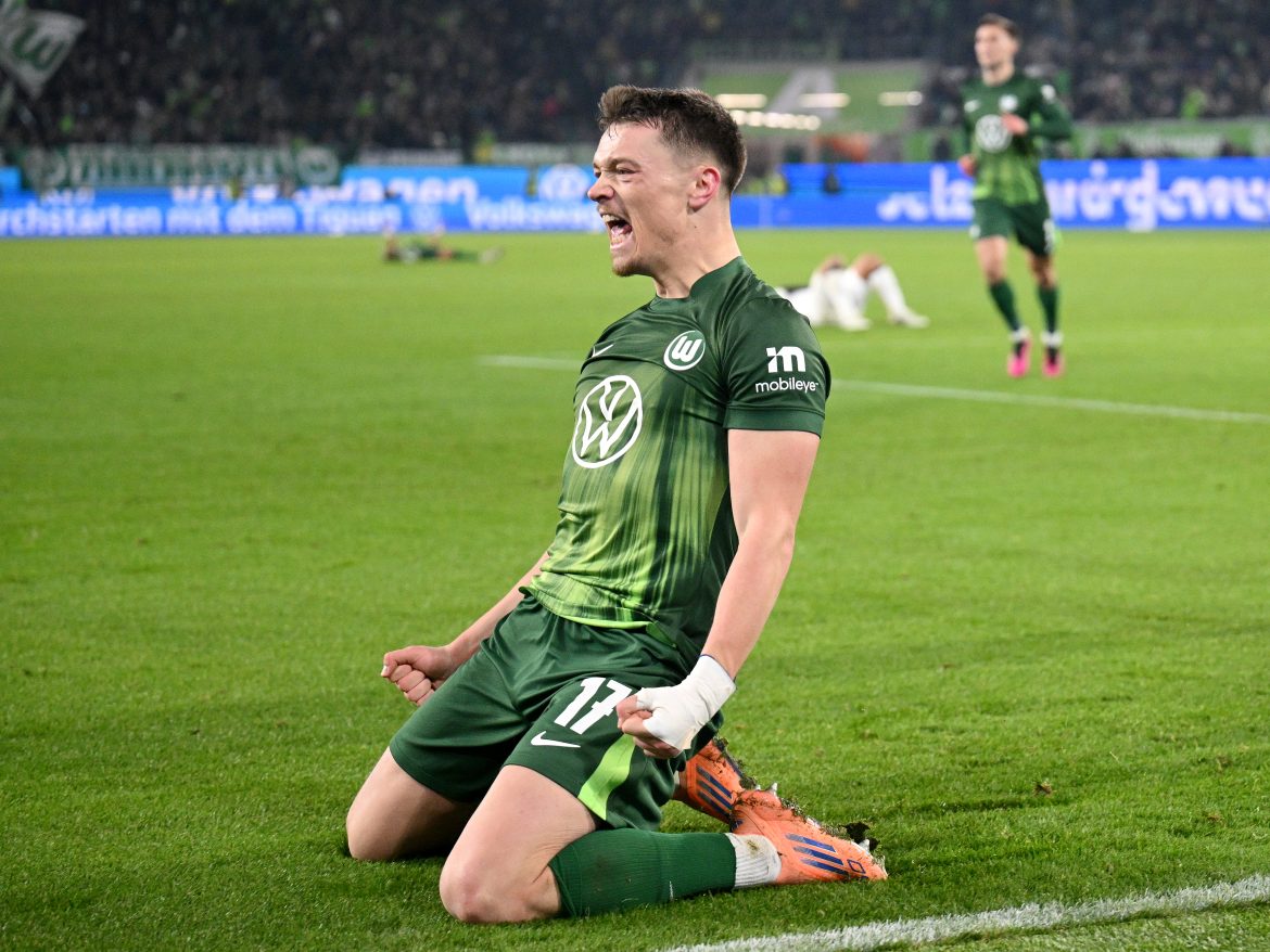 VfL Wolfsburg striker Dzenan Pejcinovic celebrates scoring the game-winning goal in a Bundesliga fixture against St. Pauli.